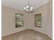 Corner dining area with tile flooring and natural light from two windows at 3530 Adelaide Ave, North Port, FL 34288