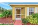 Charming front entrance with a screen door, decorative shutters and lush landscaping at 3530 Adelaide Ave, North Port, FL 34288