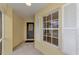 Inviting front porch featuring a decorative front door, window with shutters, and neutral tones at 3530 Adelaide Ave, North Port, FL 34288