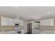 Bright kitchen featuring stainless steel appliances, white cabinets, and modern fixtures at 3530 Adelaide Ave, North Port, FL 34288