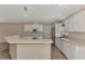 Bright kitchen featuring stainless steel appliances, white cabinets, and an open breakfast bar at 3530 Adelaide Ave, North Port, FL 34288