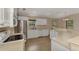 Spacious kitchen with stainless steel appliances, white cabinetry, and tile flooring at 3530 Adelaide Ave, North Port, FL 34288