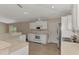 Bright kitchen with white cabinets, stainless appliances, and tile flooring at 3530 Adelaide Ave, North Port, FL 34288