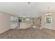 Open concept living area featuring carpet flooring, neutral walls, and a modern kitchen at 3530 Adelaide Ave, North Port, FL 34288