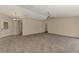 Spacious living room with neutral tones and carpet flooring, perfect for relaxation and entertaining at 3530 Adelaide Ave, North Port, FL 34288