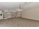 Inviting living room with carpet flooring, ceiling fan, and a seamless transition to the kitchen at 3530 Adelaide Ave, North Port, FL 34288