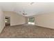 Bright living room featuring carpet flooring, neutral walls and sliding glass doors at 3530 Adelaide Ave, North Port, FL 34288