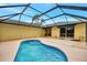 A sun-drenched pool with a screened enclosure provides privacy at 3530 Adelaide Ave, North Port, FL 34288