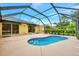Screened pool with a sun deck and views of the backyard at 3530 Adelaide Ave, North Port, FL 34288