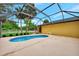 Pool with a sun deck and views of the lush landscaping at 3530 Adelaide Ave, North Port, FL 34288
