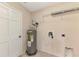 Utility room with water heater, shelving, and hookups at 3530 Adelaide Ave, North Port, FL 34288