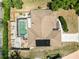 Aerial view of property showcasing a pool, patio, solar panels, and well-kept lawn at 3600 Aster Dr, Sarasota, FL 34233