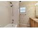 Bathroom with tiled shower and floral wallpaper at 3600 Aster Dr, Sarasota, FL 34233