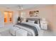 Bright bedroom featuring a serene ambiance and an adjacent en suite bathroom at 3600 Aster Dr, Sarasota, FL 34233
