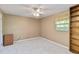 Carpeted bedroom with built-in shelves and a window at 3600 Aster Dr, Sarasota, FL 34233