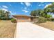 Inviting one-story home with a two-car garage, screened entrance, and a spacious concrete driveway at 3600 Aster Dr, Sarasota, FL 34233