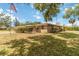 Charming single-story home with well-maintained landscaping and an American flag waving in the front yard at 3600 Aster Dr, Sarasota, FL 34233