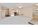 Spacious and bright living room with plush carpet and views to the dining area at 3600 Aster Dr, Sarasota, FL 34233