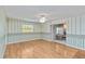 Spacious living room with hardwood floors, decorative wallpaper, and a ceiling fan at 3600 Aster Dr, Sarasota, FL 34233