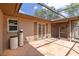 Outdoor patio with tile flooring, screened enclosure, and access to the home's interior at 3600 Aster Dr, Sarasota, FL 34233