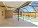 Enclosed pool features a screened lanai, a concrete patio, and a wood fence at 3600 Aster Dr, Sarasota, FL 34233