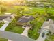 Aerial view of a home with lush landscaping, a long driveway, and access to a golf course at 3941 Spyglass Hill Rd, Sarasota, FL 34238
