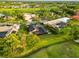 Aerial view of home, golf course, and surrounding community with lush greenery at 3941 Spyglass Hill Rd, Sarasota, FL 34238