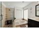 Bathroom showcasing a walk-in shower, soaking tub with tile surround, and dark wood cabinetry at 3941 Spyglass Hill Rd, Sarasota, FL 34238