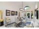 Chic dining room with a glass table, modern chairs, and unique artwork, illuminated by a stylish chandelier at 3941 Spyglass Hill Rd, Sarasota, FL 34238