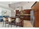 Stylish kitchen featuring dark wood cabinetry, granite countertops, stainless steel appliances, and a central island with seating at 3941 Spyglass Hill Rd, Sarasota, FL 34238