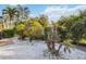 Lush landscaping featuring palm trees and white gravel ground covering at 3941 Spyglass Hill Rd, Sarasota, FL 34238