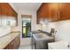 Well-organized laundry room featuring wooden cabinets, granite countertops, and a convenient washer and dryer setup at 3941 Spyglass Hill Rd, Sarasota, FL 34238