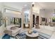 Elegant living room featuring a modern fireplace, neutral decor, and sliding glass doors that lead to an outdoor patio at 3941 Spyglass Hill Rd, Sarasota, FL 34238