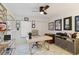 Home office featuring a modern desk, shelving, window, and ample lighting for a comfortable workspace at 3941 Spyglass Hill Rd, Sarasota, FL 34238