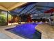 Twilight view of the screened-in pool with manicured landscaping, offers a tranquil and private outdoor experience at 3941 Spyglass Hill Rd, Sarasota, FL 34238