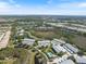 Aerial view of condo community with a pool, lakes, and lush greenery providing a serene living environment at 400 Laurel Lake Dr # 104, Venice, FL 34292