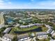 Expansive aerial view of a condo community, showcasing the lakes, pools, and well-maintained landscaping at 400 Laurel Lake Dr # 104, Venice, FL 34292
