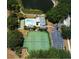 Aerial view of estate featuring pool, tennis courts, lush landscaping, and a private pond at 400 Laurel Lake Dr # 104, Venice, FL 34292