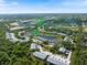 Beautiful aerial view of the condo community featuring a clubhouse, pool, and lush landscaping at 400 Laurel Lake Dr # 104, Venice, FL 34292