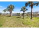 Spacious backyard featuring mature landscaping, picturesque water views and community surroundings at 400 Laurel Lake Dr # 104, Venice, FL 34292