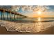 Beautiful beach at sunset with a long pier in the background at 400 Laurel Lake Dr # 104, Venice, FL 34292