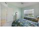 Bright bedroom with twin beds, light walls, and natural light streaming through the window at 400 Laurel Lake Dr # 104, Venice, FL 34292