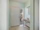 Bright foyer featuring tiled floor, light blue walls, and a decorative console table at 400 Laurel Lake Dr # 104, Venice, FL 34292