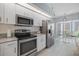 Modern kitchen with stainless steel appliances, granite countertops, and ample cabinet space at 400 Laurel Lake Dr # 104, Venice, FL 34292
