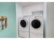 Convenient laundry room with front loading washer and dryer and ample storage cabinets at 400 Laurel Lake Dr # 104, Venice, FL 34292