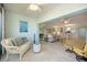 Bright and open living area featuring comfortable seating and serene decor with a pass-through to the kitchen at 400 Laurel Lake Dr # 104, Venice, FL 34292