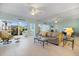 Bright living room with plush seating, light wood floors, and large windows overlooking the lush landscaping at 400 Laurel Lake Dr # 104, Venice, FL 34292