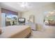 Serene main bedroom with water views, soft lighting, and neutral decor for a tranquil retreat at 400 Laurel Lake Dr # 104, Venice, FL 34292