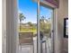 View from patio with chairs overlooking landscaped grounds and a serene lake at 400 Laurel Lake Dr # 104, Venice, FL 34292