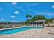 Community pool area with ample lounge chairs, palm trees, and beautiful views at 400 Laurel Lake Dr # 104, Venice, FL 34292